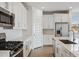 Kitchen featuring stainless steel appliances, subway tile backsplash, white cabinets, and quartz counters at 7165 S Bruins Rd, Gold Canyon, AZ 85118