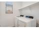 Bright laundry area featuring a modern washer and dryer, plus a convenient storage shelf at 7165 S Bruins Rd, Gold Canyon, AZ 85118