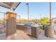 Outdoor grilling area complete with stainless steel grill, countertop, and trash receptacle for outdoor dining at 7165 S Bruins Rd, Gold Canyon, AZ 85118