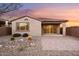 Covered patio opens to backyard with desert landscaping and perimeter fence at 7165 S Bruins Rd, Gold Canyon, AZ 85118