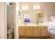 Bright bathroom featuring a double vanity, a bathtub, and a separate toilet area at 723 W Canary Way, Chandler, AZ 85286