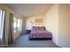 Cozy bedroom with a patterned bedspread and large windows at 723 W Canary Way, Chandler, AZ 85286