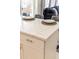 Close-up of a kitchen island with a white countertop and seating, with the living room in the background at 723 W Canary Way, Chandler, AZ 85286