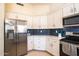 Contemporary kitchen with stainless steel appliances, elegant white cabinets, and sleek countertops at 723 W Canary Way, Chandler, AZ 85286