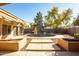 This backyard features a serene pool with a fountain, complemented by lush landscaping and a paved patio for relaxation at 723 W Canary Way, Chandler, AZ 85286