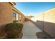 The side yard has a concrete pad, masonry block wall, and low-maintenance desert landscaping at 723 W Canary Way, Chandler, AZ 85286