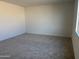 A neutral bedroom with carpet and a window providing ample natural light at 7654 W Tether Trl, Peoria, AZ 85383