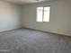 Neutral bedroom with a carpeted floor and a window for plenty of natural light at 7654 W Tether Trl, Peoria, AZ 85383