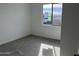 Bright bedroom featuring soft gray carpet, natural light and a neutral color palette at 7654 W Tether Trl, Peoria, AZ 85383