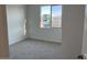 Cozy bedroom with carpet flooring, a window offering natural light, and fresh paint at 7654 W Tether Trl, Peoria, AZ 85383