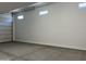 Spacious two car garage with white walls, concrete floors, and overhead lighting at 7654 W Tether Trl, Peoria, AZ 85383