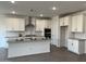 A modern kitchen with white cabinets, gray countertops, a large island, and stainless steel appliances at 7654 W Tether Trl, Peoria, AZ 85383