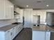 Modern kitchen featuring stainless appliances, a large island and ample white cabinetry at 7654 W Tether Trl, Peoria, AZ 85383