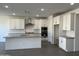 Bright, spacious kitchen with stainless steel appliances, gray countertops, and white cabinetry at 7654 W Tether Trl, Peoria, AZ 85383