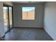 A bright living room with wood flooring and a large window at 7654 W Tether Trl, Peoria, AZ 85383