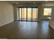 Bright living room featuring sliding glass doors to the backyard and light tile flooring at 7654 W Tether Trl, Peoria, AZ 85383