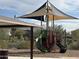 Community playground with sunshade and green slide at 7654 W Tether Trl, Peoria, AZ 85383