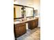 Elegant Primary bathroom featuring dual sinks, granite counters, framed mirrors, and wood-look tile flooring at 9405 S 47Th Ave, Laveen, AZ 85339