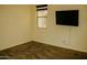 Empty bedroom with neutral walls, carpet, and an outside view through window at 9405 S 47Th Ave, Laveen, AZ 85339