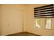 Bright bedroom with modern window shades, carpeted floors, and closet for storage at 9405 S 47Th Ave, Laveen, AZ 85339