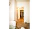 Hallway with tile flooring leading to multiple rooms, with neutral paint and modern lighting at 9405 S 47Th Ave, Laveen, AZ 85339