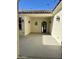 Covered patio area with decorative lighting and a wrought iron doorway, perfect for entertaining at 9405 S 47Th Ave, Laveen, AZ 85339