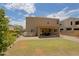 Exterior view of the house, highlighting the patio, built-in grill, and landscaped backyard at 9556 W Frank Ave, Peoria, AZ 85382