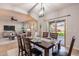 Dining area with wood table and seating for six, adjacent to the kitchen and overlooking the living room at 9556 W Frank Ave, Peoria, AZ 85382