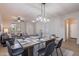 Open-concept dining area with stylish table, pendant lighting, and views into the living room at 9556 W Frank Ave, Peoria, AZ 85382