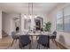 Modern dining room featuring a rustic wooden table, seating for six, and plenty of natural light at 9556 W Frank Ave, Peoria, AZ 85382