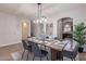 Inviting dining space with a beautifully set table and chairs, and modern pendant lighting at 9556 W Frank Ave, Peoria, AZ 85382