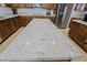 Close up of kitchen island featuring granite countertops and matching wood cabinets below at 9556 W Frank Ave, Peoria, AZ 85382