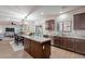 Spacious kitchen featuring wood cabinetry, granite countertops, and an open layout to the dining area at 9556 W Frank Ave, Peoria, AZ 85382