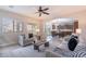 Open living room with comfortable seating, wood look tile floors, and an arched entryway leading to the dining area at 9556 W Frank Ave, Peoria, AZ 85382