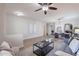 Inviting living room showcasing an open floor plan and stylish decor with a seamless flow to the dining area at 9556 W Frank Ave, Peoria, AZ 85382