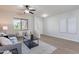 Bright living room with wood floors, neutral color palette, and a cozy seating arrangement near a window at 9556 W Frank Ave, Peoria, AZ 85382