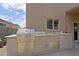 Outdoor kitchen with grill, prep area, and storage, perfect for entertaining outdoors at 9556 W Frank Ave, Peoria, AZ 85382