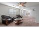 Cozy sitting area featuring comfortable leather chairs, soft carpet and abundant natural light at 9556 W Frank Ave, Peoria, AZ 85382