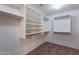 Spacious walk-in closet with custom shelving and ample storage space for clothes and accessories at 9556 W Frank Ave, Peoria, AZ 85382