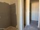 Incomplete bathroom with visible stud walls and partially installed shower, offering a glimpse into the construction process at 9618 W Parkway Dr, Tolleson, AZ 85353