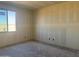 Unfinished room with a window, showcasing its potential for customization and personalization to suit the homeowner's needs at 9618 W Parkway Dr, Tolleson, AZ 85353