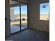 Bright room featuring sliding glass doors and a window offering abundant natural light and views of the surrounding property at 9618 W Parkway Dr, Tolleson, AZ 85353