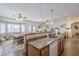 Open-concept kitchen with a breakfast bar overlooking the dining area and living room, great for entertaining at 10145 W Devonshire Dr, Arizona City, AZ 85123