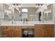 Elegant bathroom with double sinks and vanities, enhanced by stylish mirrors, and creating a luxurious spa-like experience at 104 W Windsong Dr, Phoenix, AZ 85045