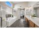 Bright bathroom featuring a soaking tub, a glass-enclosed shower, and double vanities, creating a luxurious and spa-like experience at 104 W Windsong Dr, Phoenix, AZ 85045