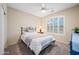 Cozy bedroom with a ceiling fan and a large window covered with shutters at 104 W Windsong Dr, Phoenix, AZ 85045