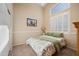 Bright bedroom featuring vaulted ceiling, shuttered windows, and neutral tones at 104 W Windsong Dr, Phoenix, AZ 85045