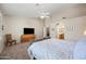 Spacious bedroom featuring a comfortable bed and TV, providing a relaxing retreat with ample natural light and style at 104 W Windsong Dr, Phoenix, AZ 85045