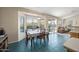 Bright dining area with a dining table, a view of the pool through large windows and sliding glass doors at 104 W Windsong Dr, Phoenix, AZ 85045