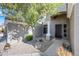 Inviting front entrance with a decorative door, shaded porch, and desert landscaping at 104 W Windsong Dr, Phoenix, AZ 85045